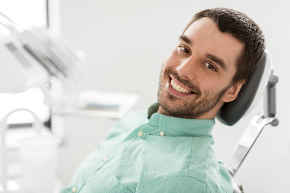 havertown man smiling in dental chair after teeth cleaning