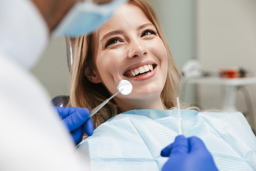 woman smiling in a dental chair in havertown